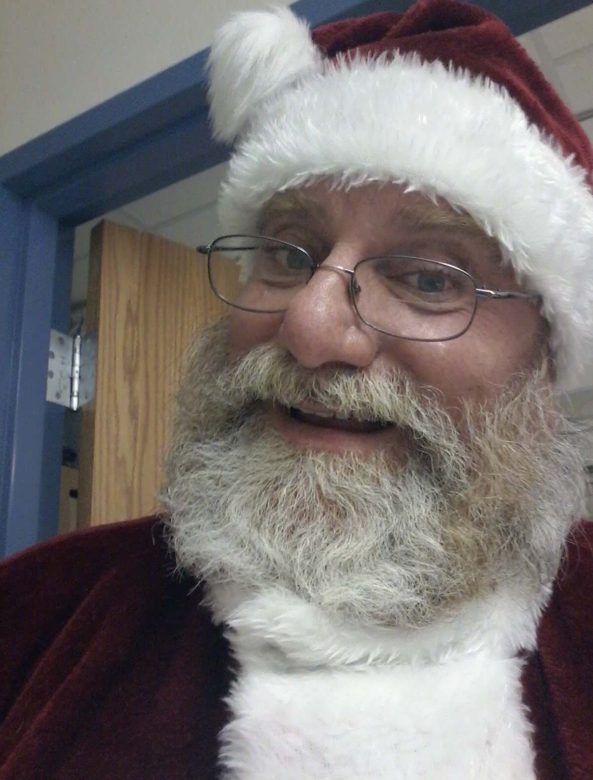 Close-up of Santa smiling in his hat and glasses